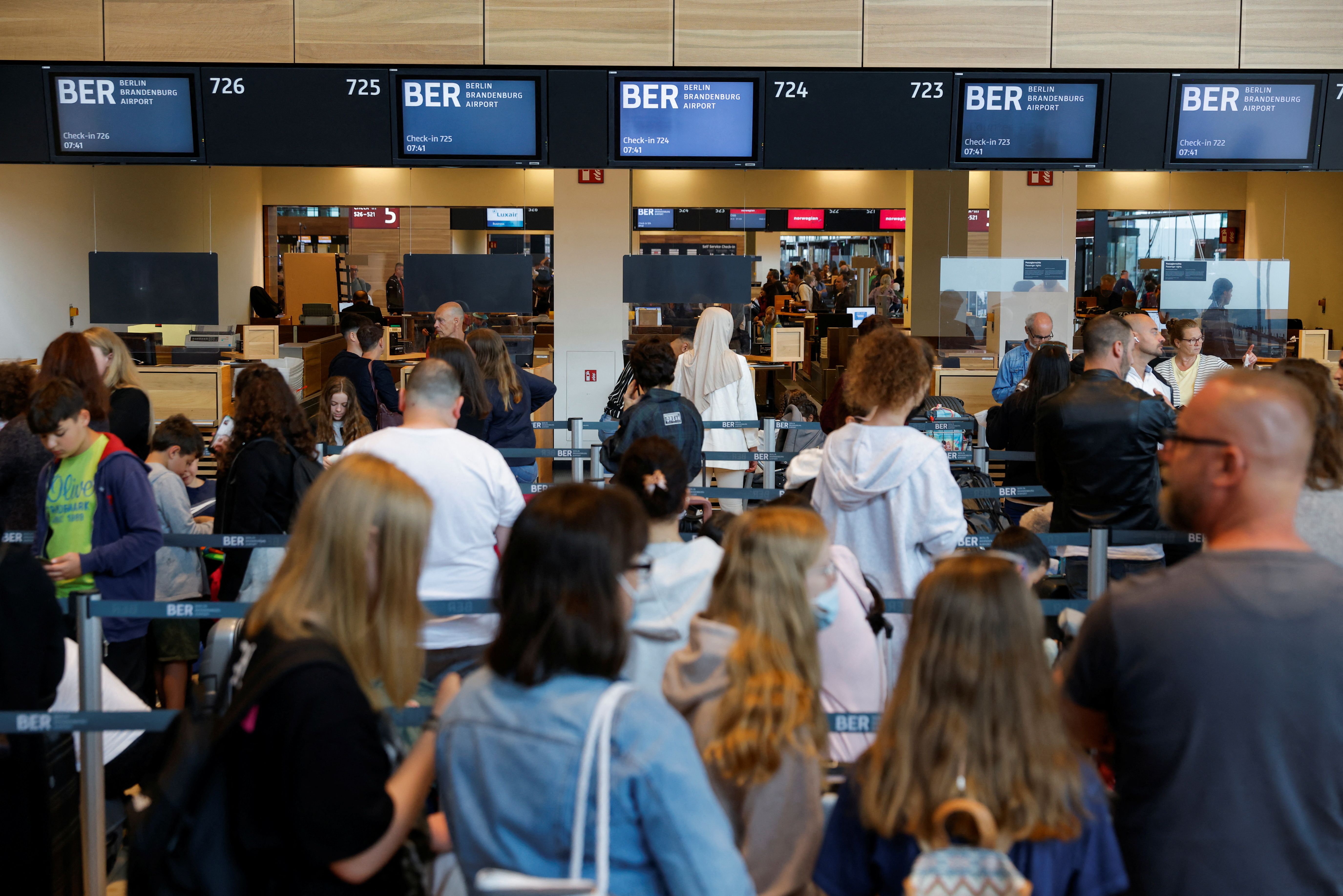 Travelers wait in line at Brandenburg airport in Berlin