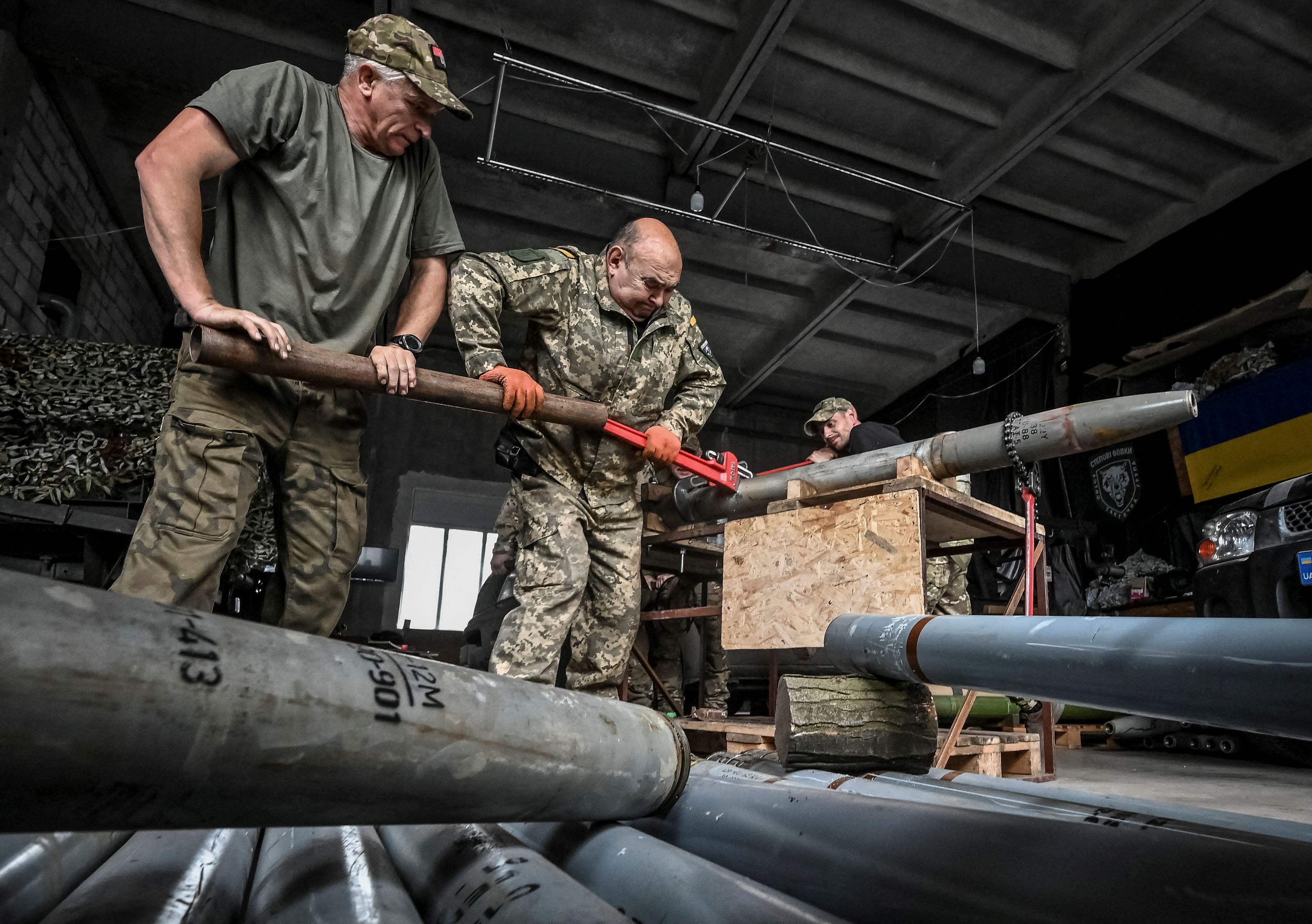 Members of the company tactical group “Steppe Wolves” of the Voluntary Formation of the Zaporizhzhia Territorial Community disassemble a shell for a BM-21 Grad multiple launch rocket system to convert it for use with a handmade small MLRS for firing toward Russian troops, amid Russia’s attack on Ukraine, in Zaporizhzhia region, Ukraine April 26, 2024. REUTERS/Stringer