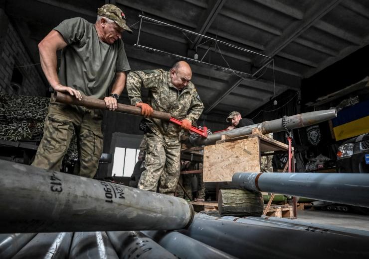 Members of the company tactical group “Steppe Wolves” of the Voluntary Formation of the Zaporizhzhia Territorial Community disassemble a shell for a BM-21 Grad multiple launch rocket system to convert it for use with a handmade small MLRS for firing toward Russian troops, amid Russia’s attack on Ukraine, in Zaporizhzhia region, Ukraine April 26, 2024. REUTERS/Stringer