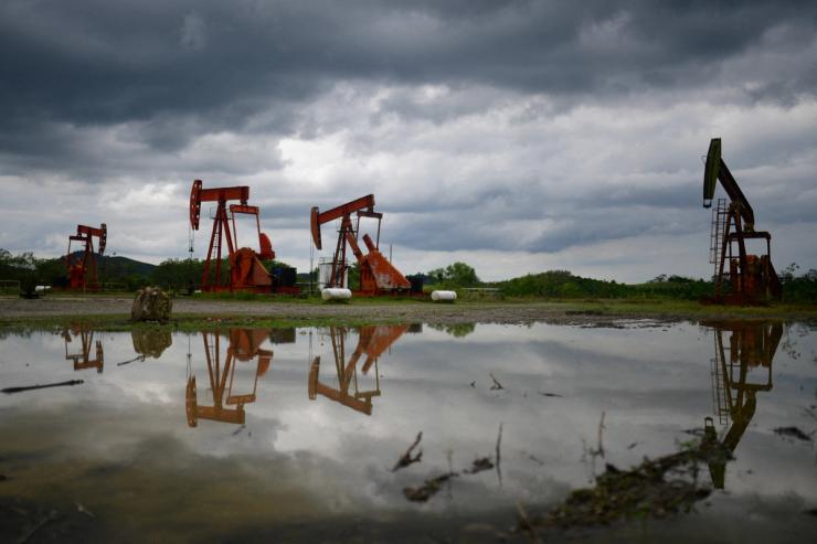 Pump jacks operate at an oil well run by Mexican state oil firm Pemex, where Indigenous communities in the Papantla region sit atop gas and oil deposits the government wants to exploit using hydraulic fracturing, or fracking, in Arroyo Florido, Veracruz state, Mexico.