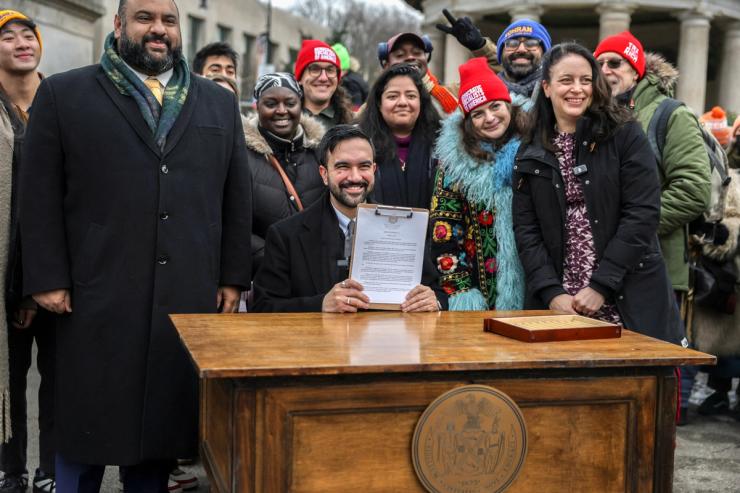 Zohran Mamdani holds a signed executive order