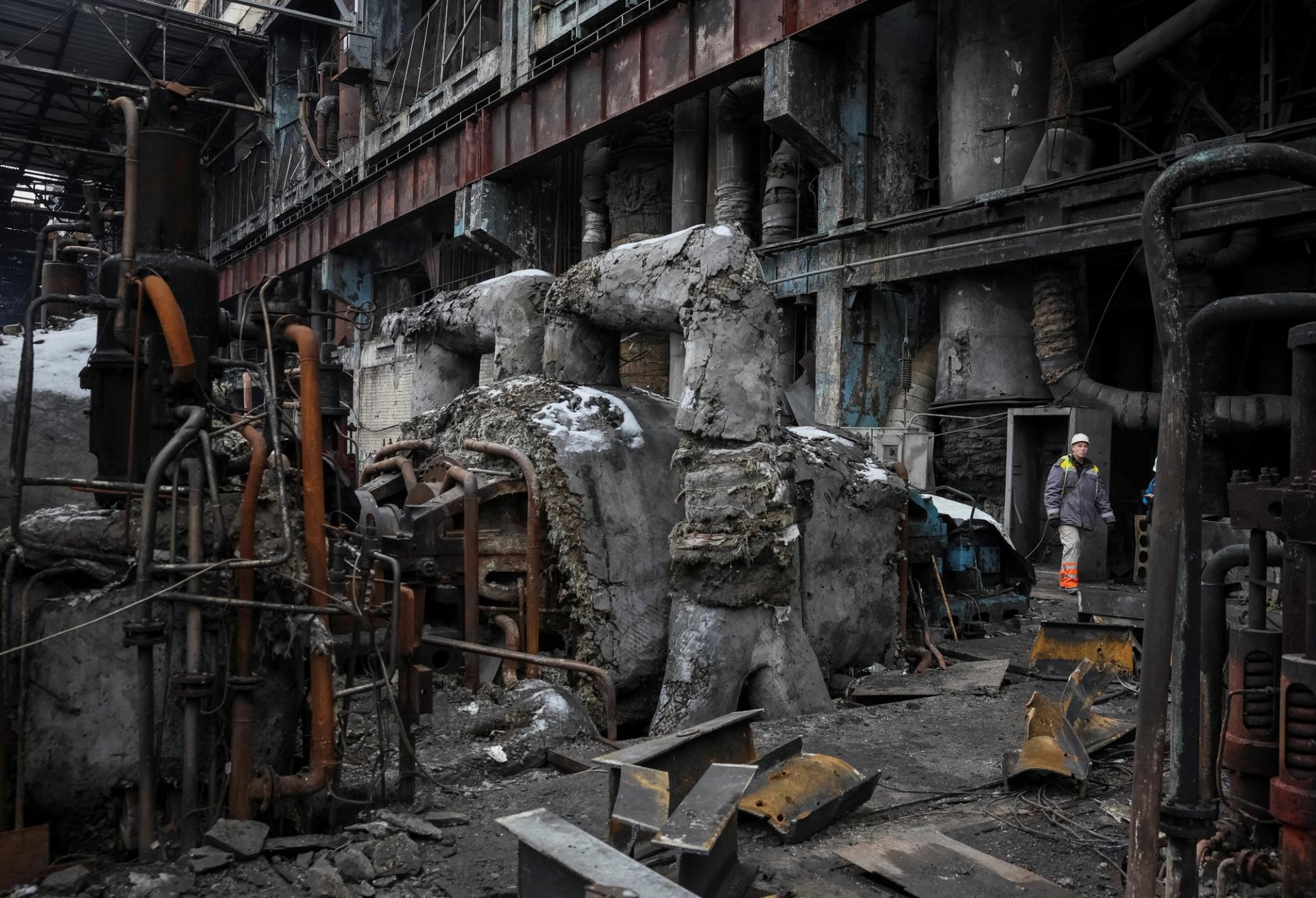 A worker walks through a thermal power plant damaged by a Russian missile strike