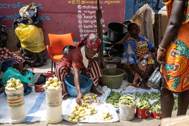 A street vendor arranges the vegetables she is selling in a street in Accra.