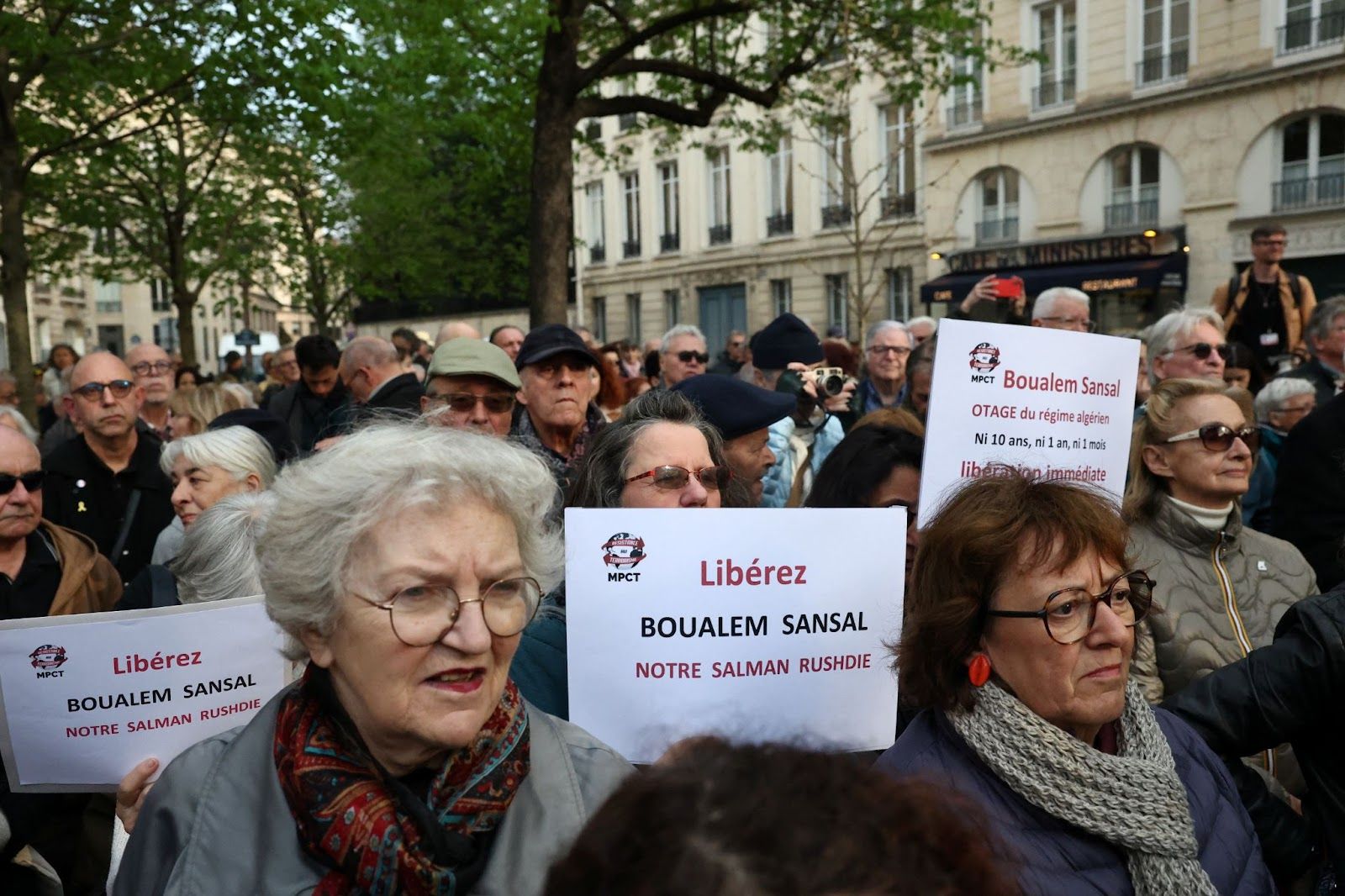 People attend a gathering in support of detained writer Boualem Sansal in Paris, France. 