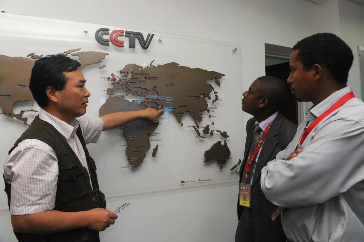 managing editor of China Central Television (CCTV) Africa Pang Xinhua (L) talking to local journalists in Nairobi.