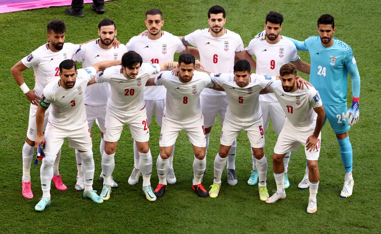 Iran players pose for a team group photo before the match