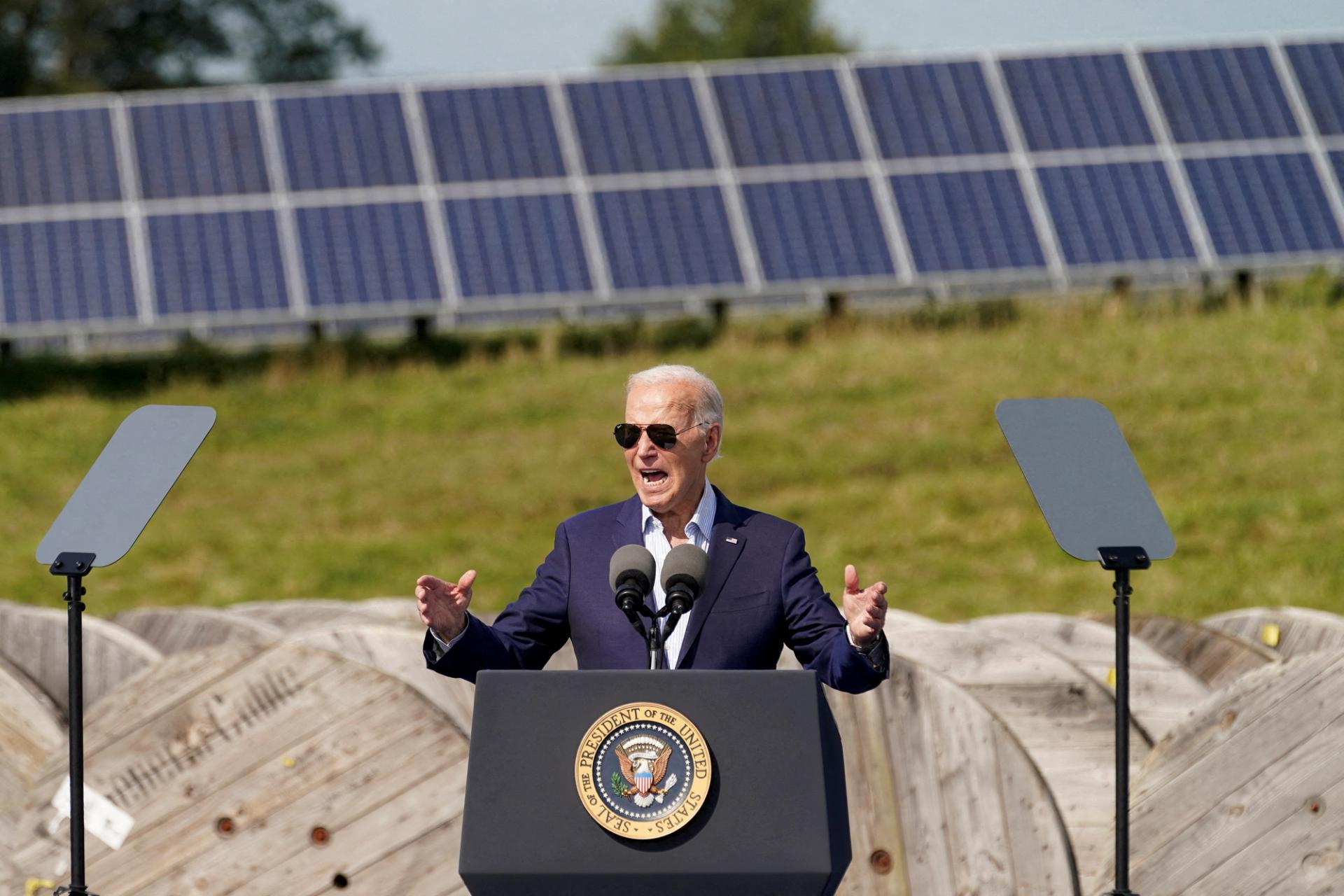 Solar panels at the background as U.S. President Joe Biden speaks during a visit to Vernon Electric Cooperative in Westby, Wisconsin.