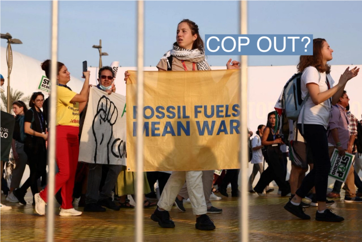People hold banners during a protest for climate justice and a ceasefire in Gaza during COP28 in Dubai