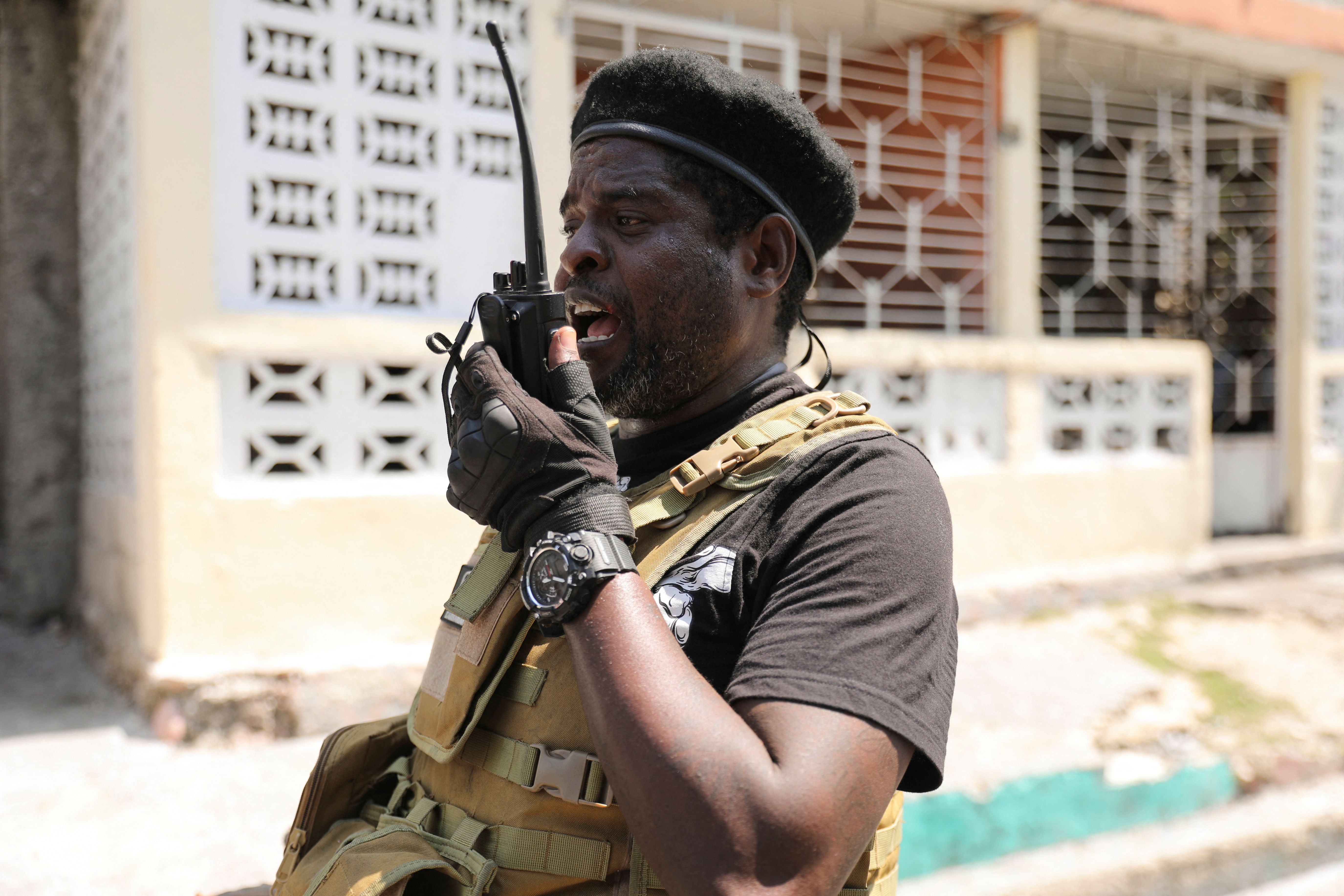 Former police officer Jimmy “Barbecue” Cherizier, and leader of an alliance of armed groups, uses a walkie talkie after addressing the media, in Port-au-Prince, Haiti, March 11, 2024. REUTERS/Ralph Tedy Erol
