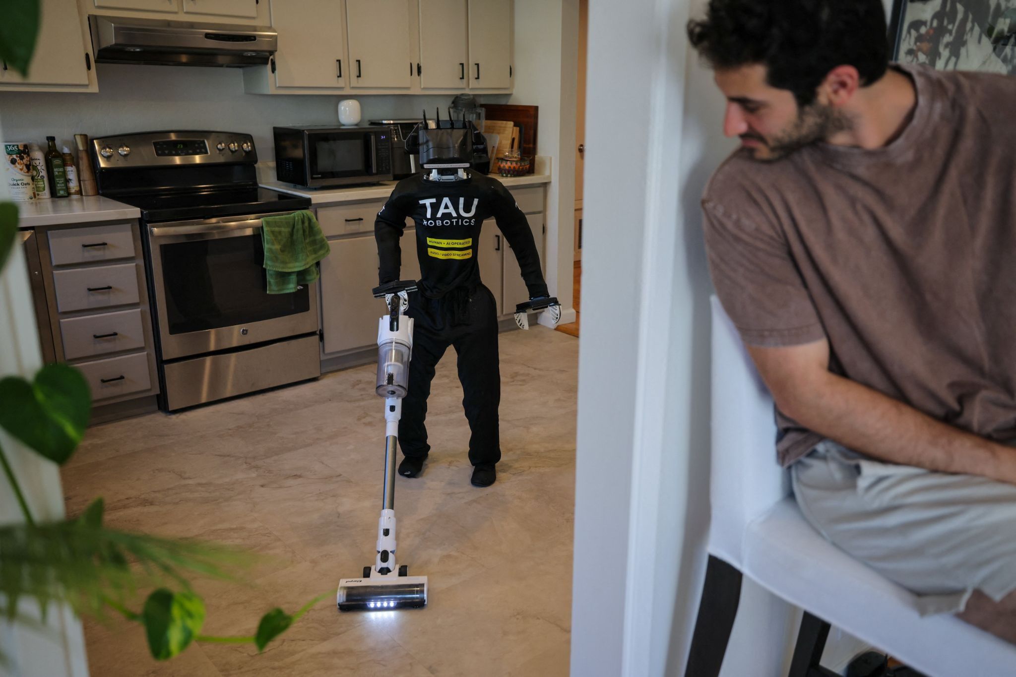 A humanoid robot vacuuming.