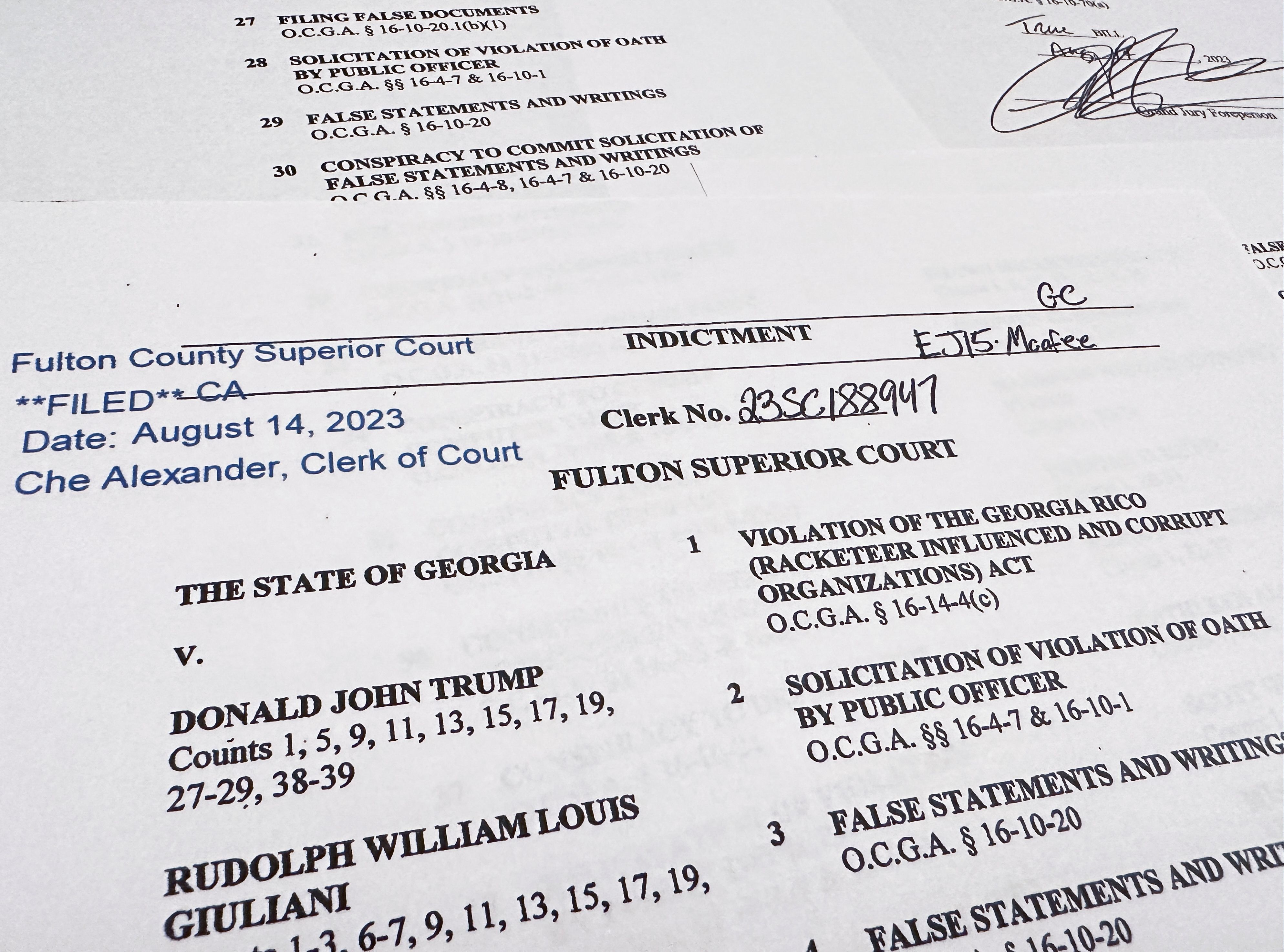 The first page of a 98-page grand jury indictment listing 19 defendants and 41 criminal counts, including felony charges of racketeering against former U.S. President Donald Trump, is seen after being released by Fulton County District Attorney Fani Willis and the Fulton County Superior Court in Atlanta, Georgia, U.S. August 14, 2023. REUTERS/Jim Bourg