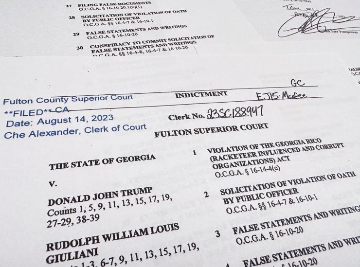 The first page of a 98-page grand jury indictment listing 19 defendants and 41 criminal counts, including felony charges of racketeering against former U.S. President Donald Trump, is seen after being released by Fulton County District Attorney Fani Willis and the Fulton County Superior Court in Atlanta, Georgia, U.S. August 14, 2023. REUTERS/Jim Bourg
