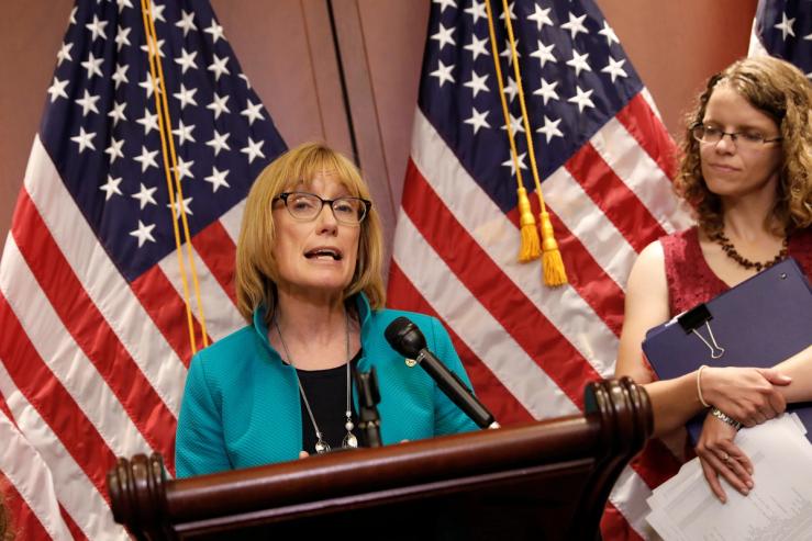 Sen. Maggie Hassan (D-NH), accompanied by children with preexisting conditions covered under the Affordable Care Act, speaks at a press conference about the Senate health care bill on Capitol Hill in Washington, U.S