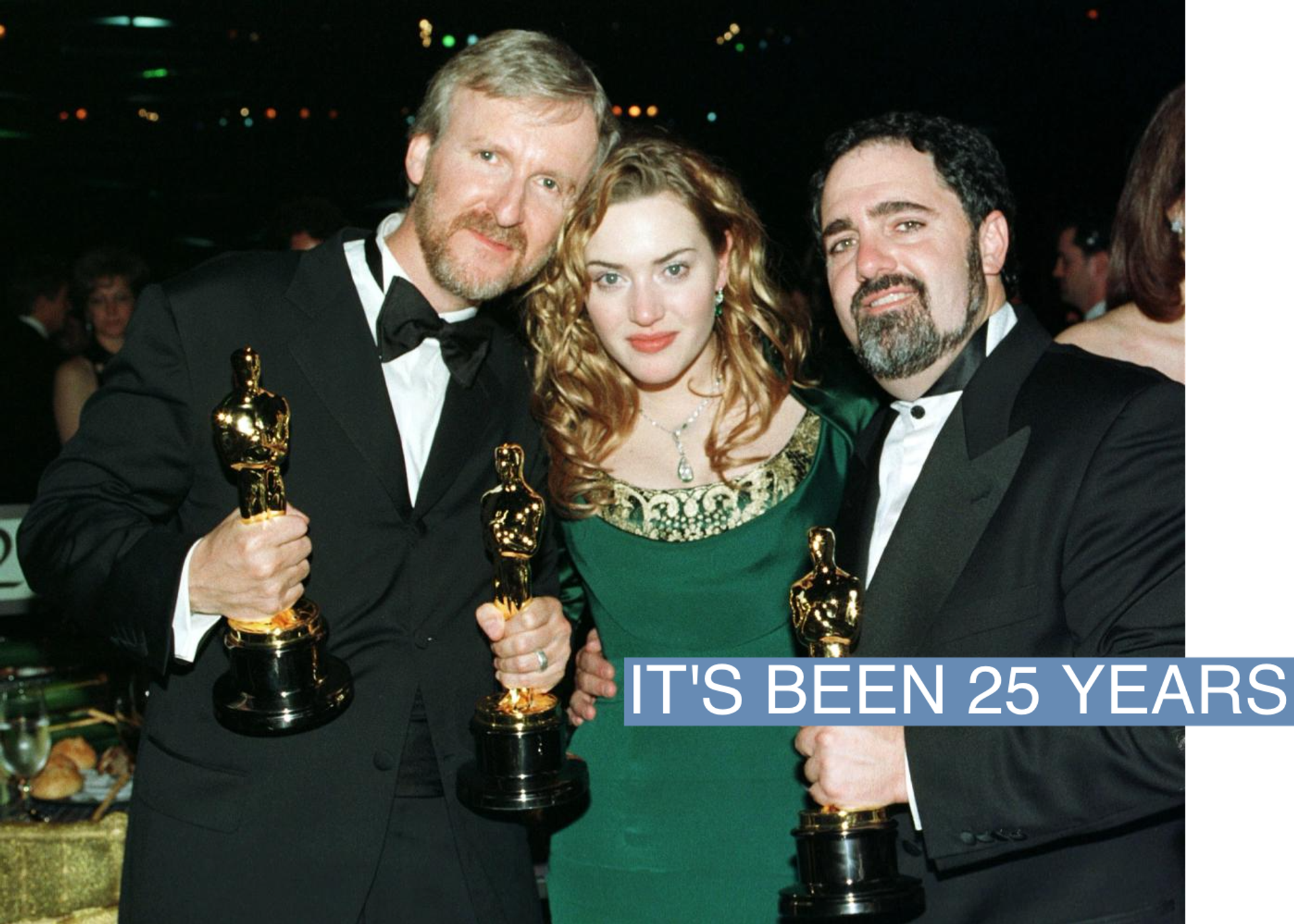 Titanic director James Cameron, actress Kate Winslet and Titanic producer Jon Landau pose for pictures with their Oscars at the Governor's Ball following the 70th annual Academy Awards at the Shrine Auditorium in Los Angeles March 23, 1998. 