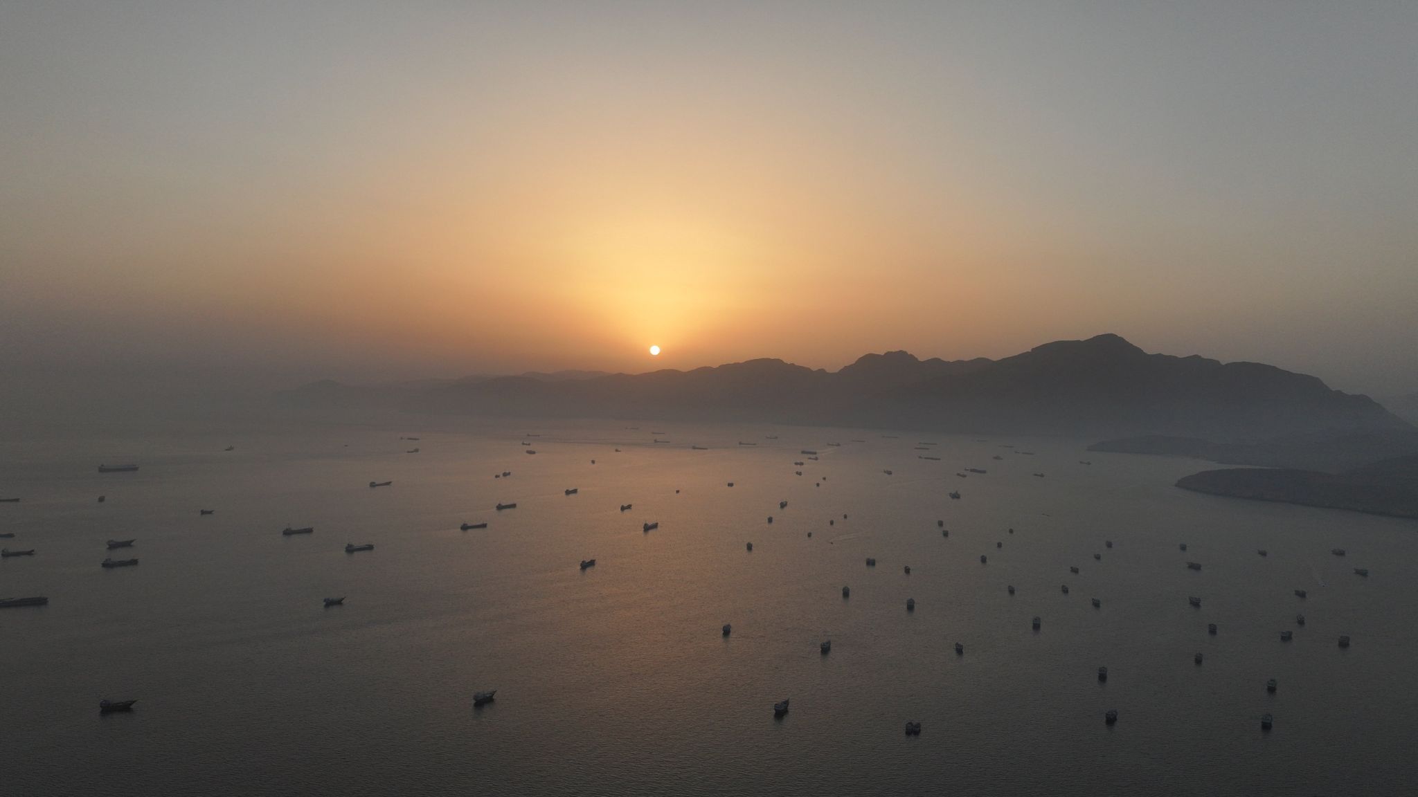 A drone view shows vessels anchored at the Strait of Hormuz. 