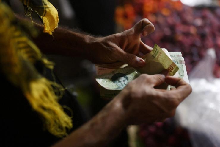 A man counting Iranian rials.