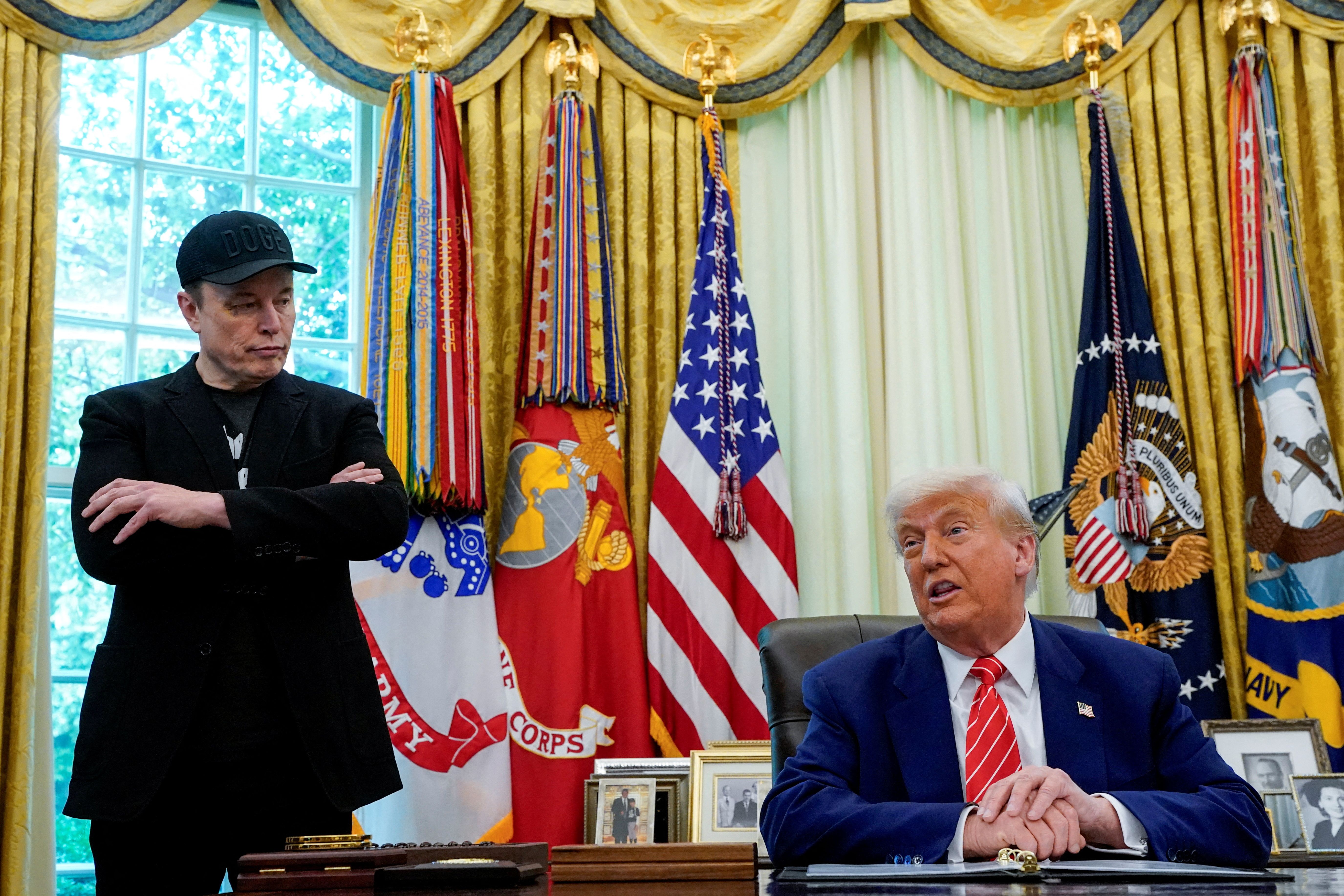 President Donald Trump and Elon Musk attend a press conference in the Oval Office.