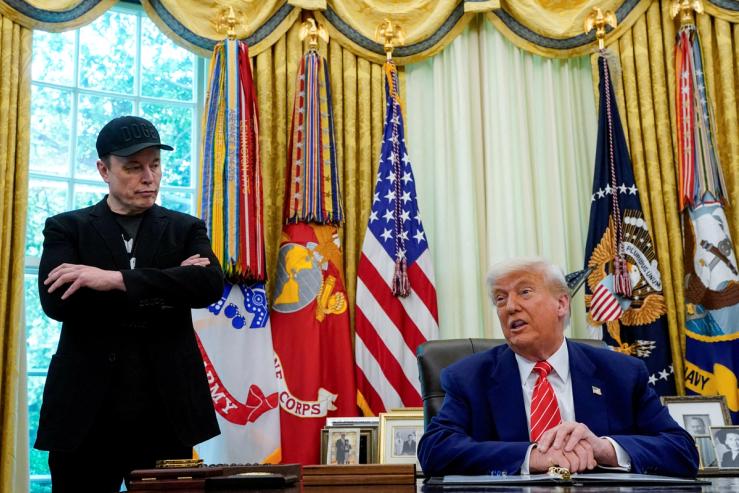 President Donald Trump and Elon Musk attend a press conference in the Oval Office.