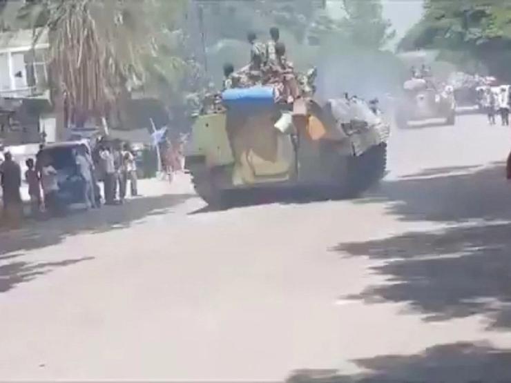 Armed men on armoured vehicles drive through Alamata, Ethiopia.
