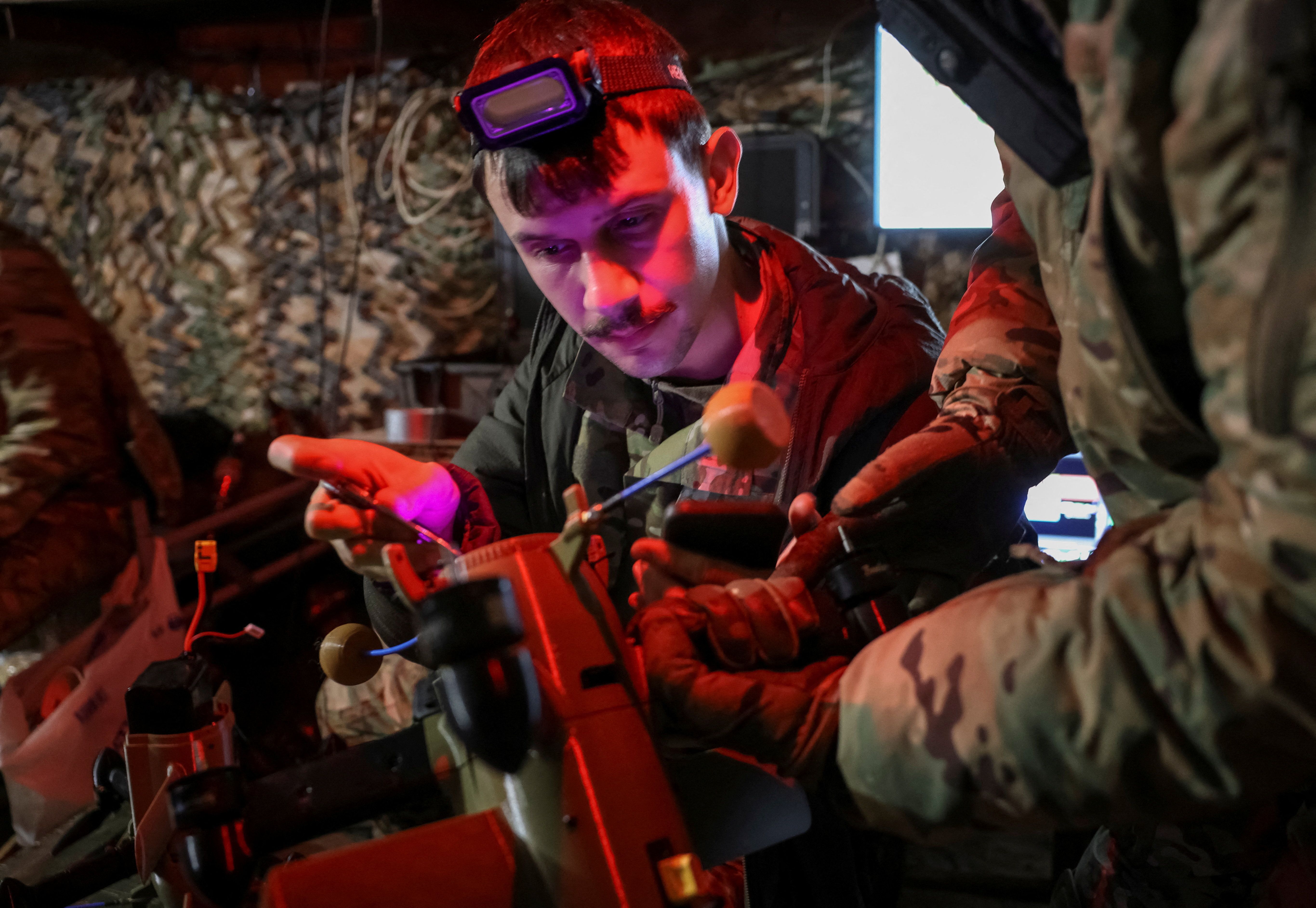 Ukrainian soldiers handle a drone