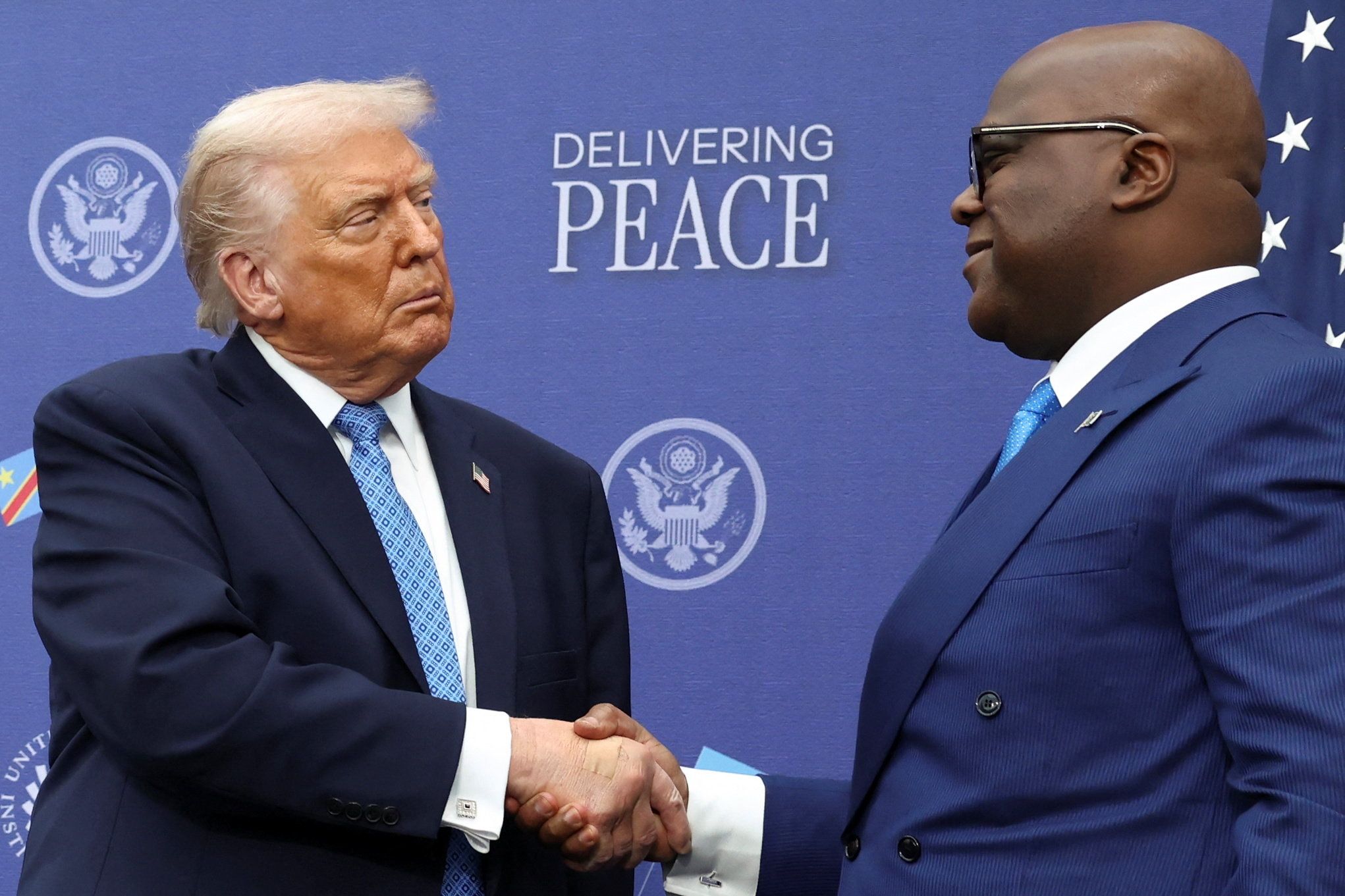 U.S. President Donald Trump shakes hands with President of the Democratic Republic of the Congo Felix Tshisekedi during a signing ceremony at the U.S. Institute of Peace in Washington, D.C., U.S., December 4, 2025. 