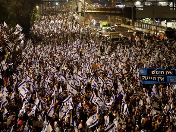 People attend a demonstration after Israeli Prime Minister Benjamin Netanyahu dismissed the defense minister and his nationalist coalition government presses on with its judicial overhaul, in Tel Aviv, Israel, March 26, 2023. REUTERS/Nir Elias