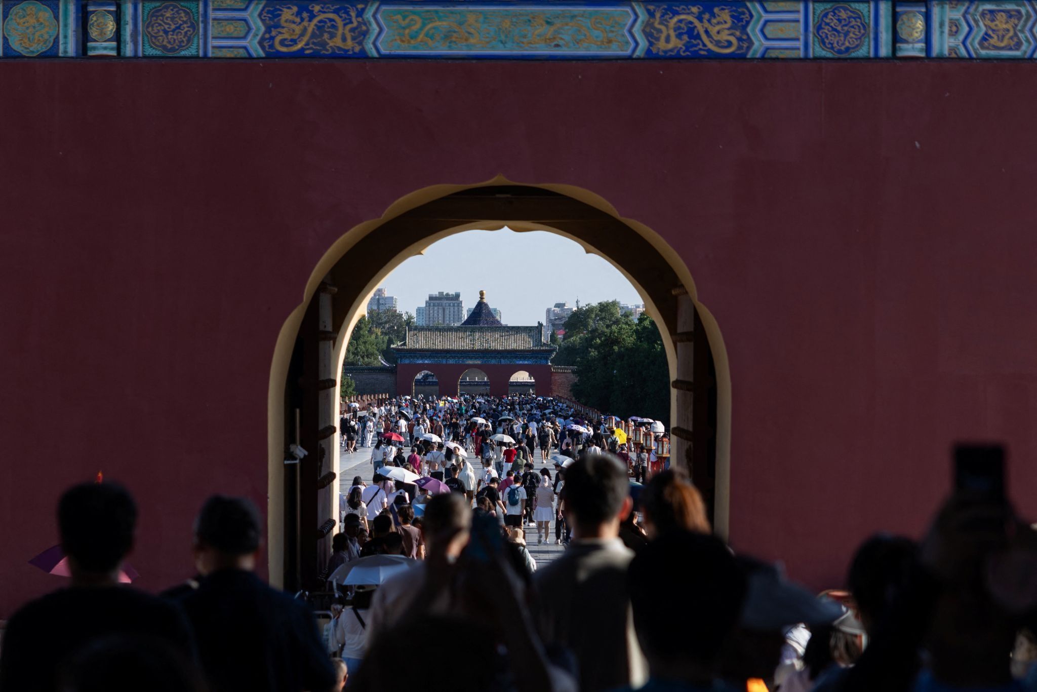 Tourists walk at the Temple of Heaven, or Tiantan Park, in Beijing