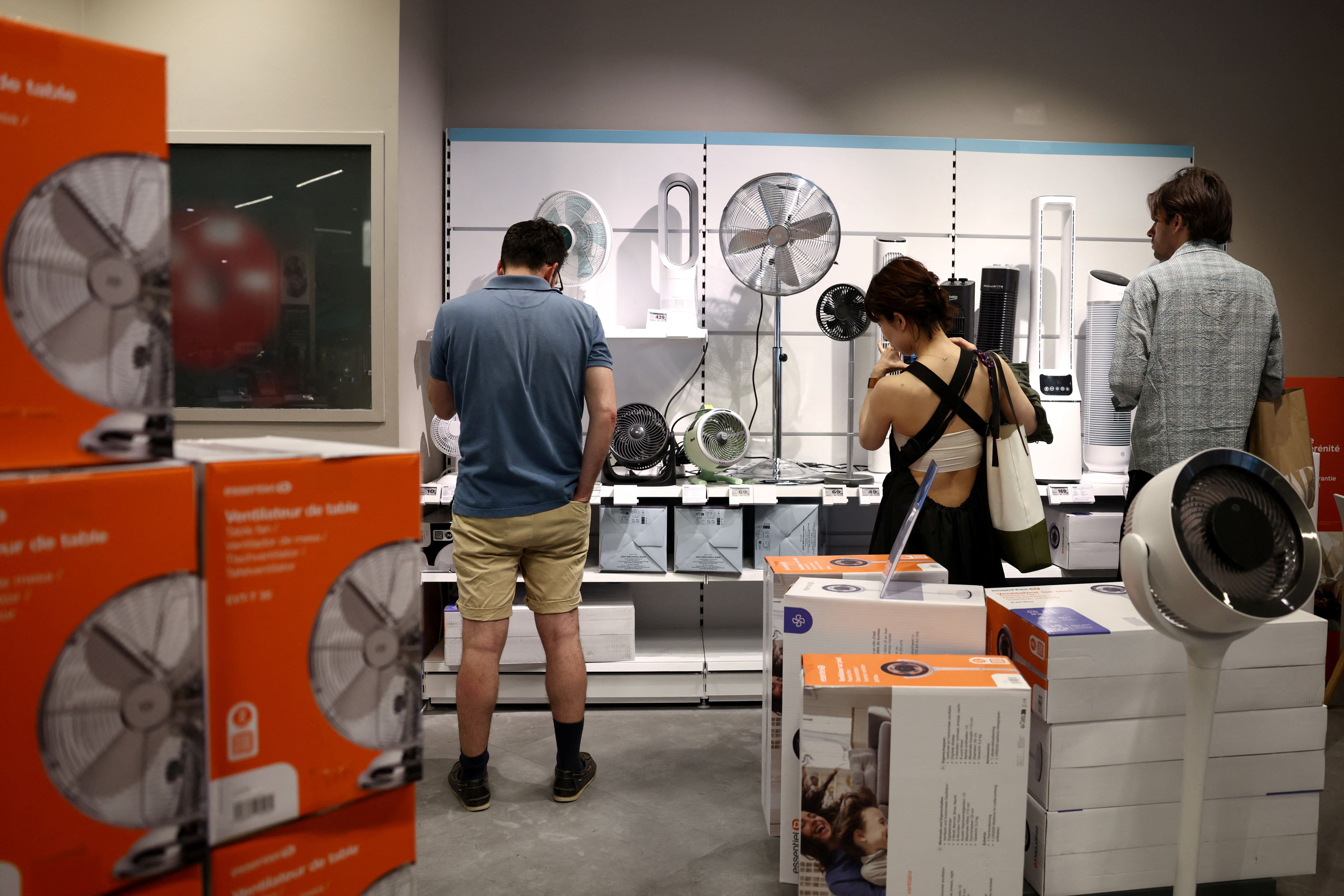 Shoppers in Paris, France browse fans and air conditioners amidst heatwave