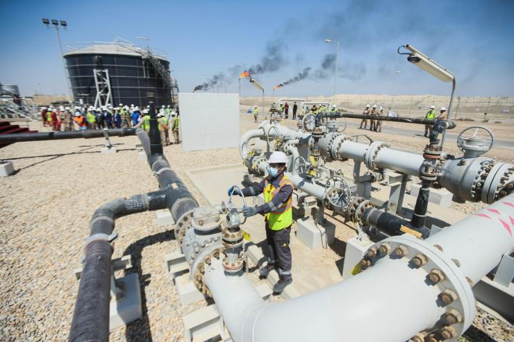 A worker checks and adjusts the valve of an oil pipeline at Majnoon oil field near Basra.