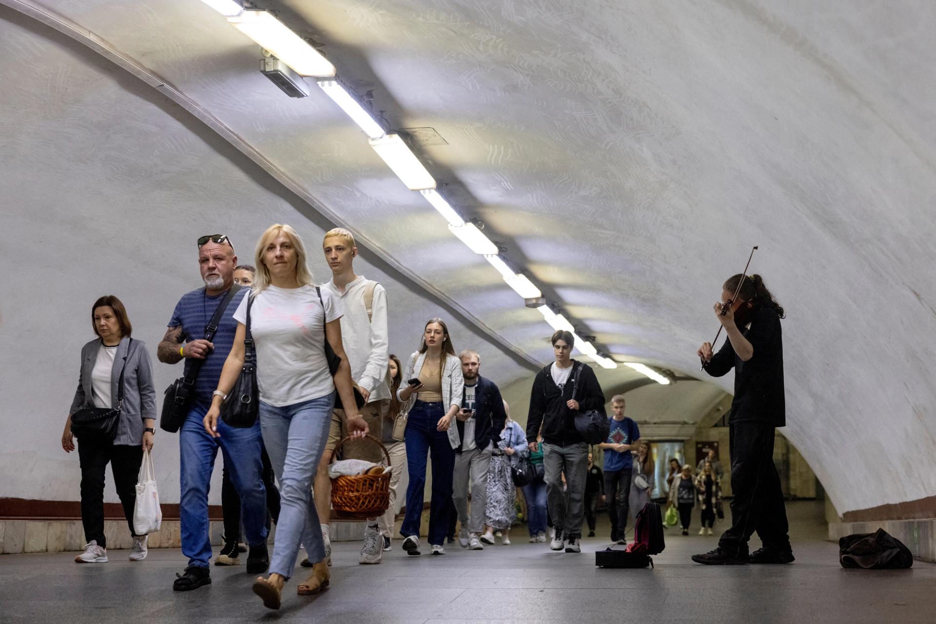 People walk through a subway station during morning rush hour in central Kyiv, Ukraine