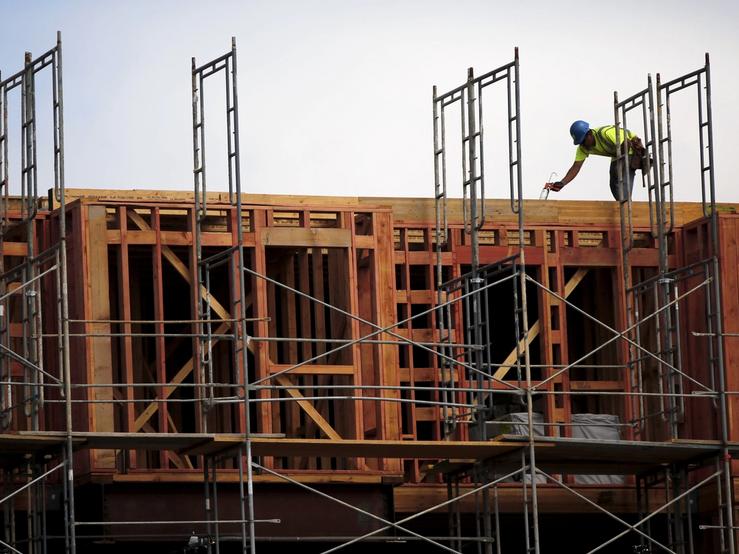 A construction worker builds framing at a housing construction project in San Francisco