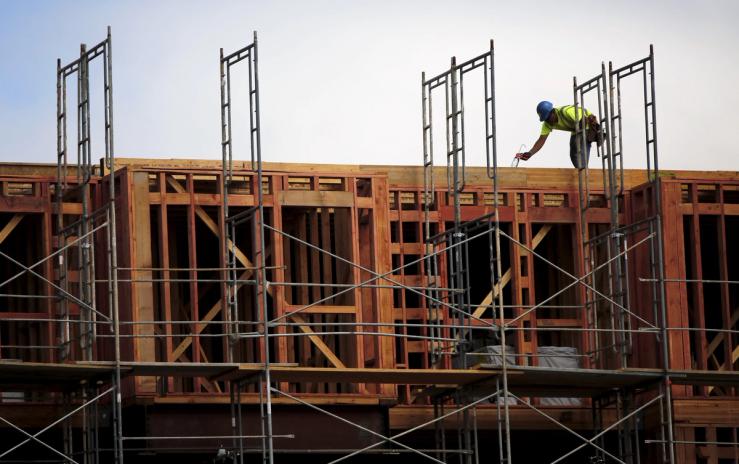 A construction worker builds framing at a housing construction project in San Francisco