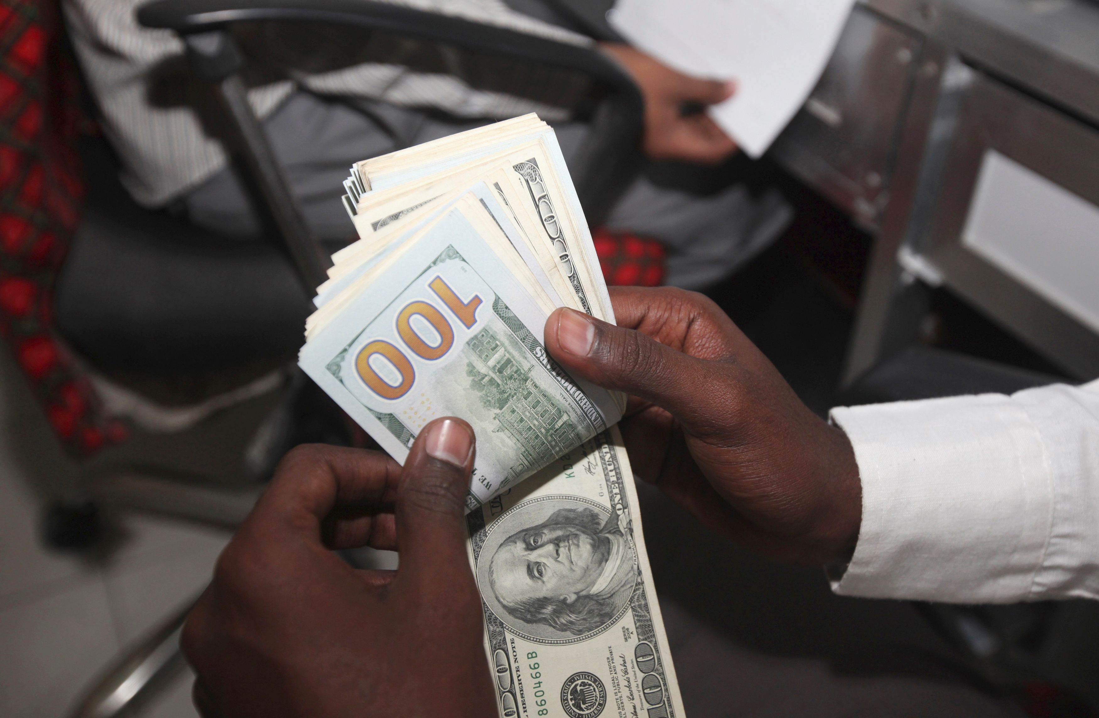 A teller counts US notes at the Dahabshill money transfer office in Mogadishu on Feb. 16, 2015. 