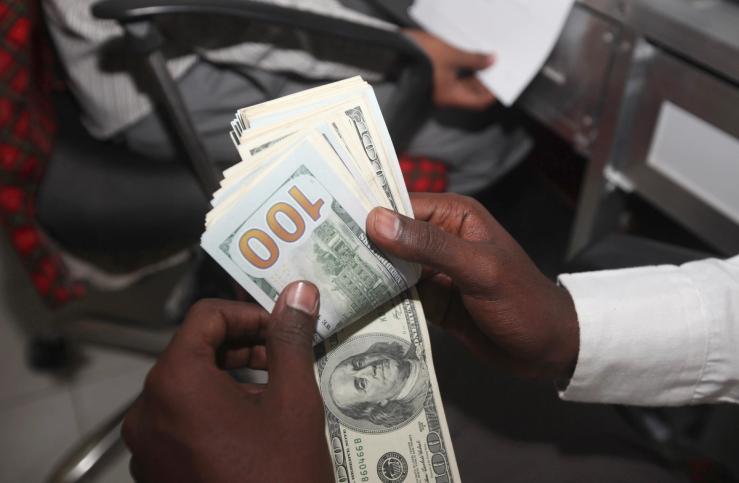 A teller counts US notes at the Dahabshill money transfer office in Mogadishu on Feb. 16, 2015.