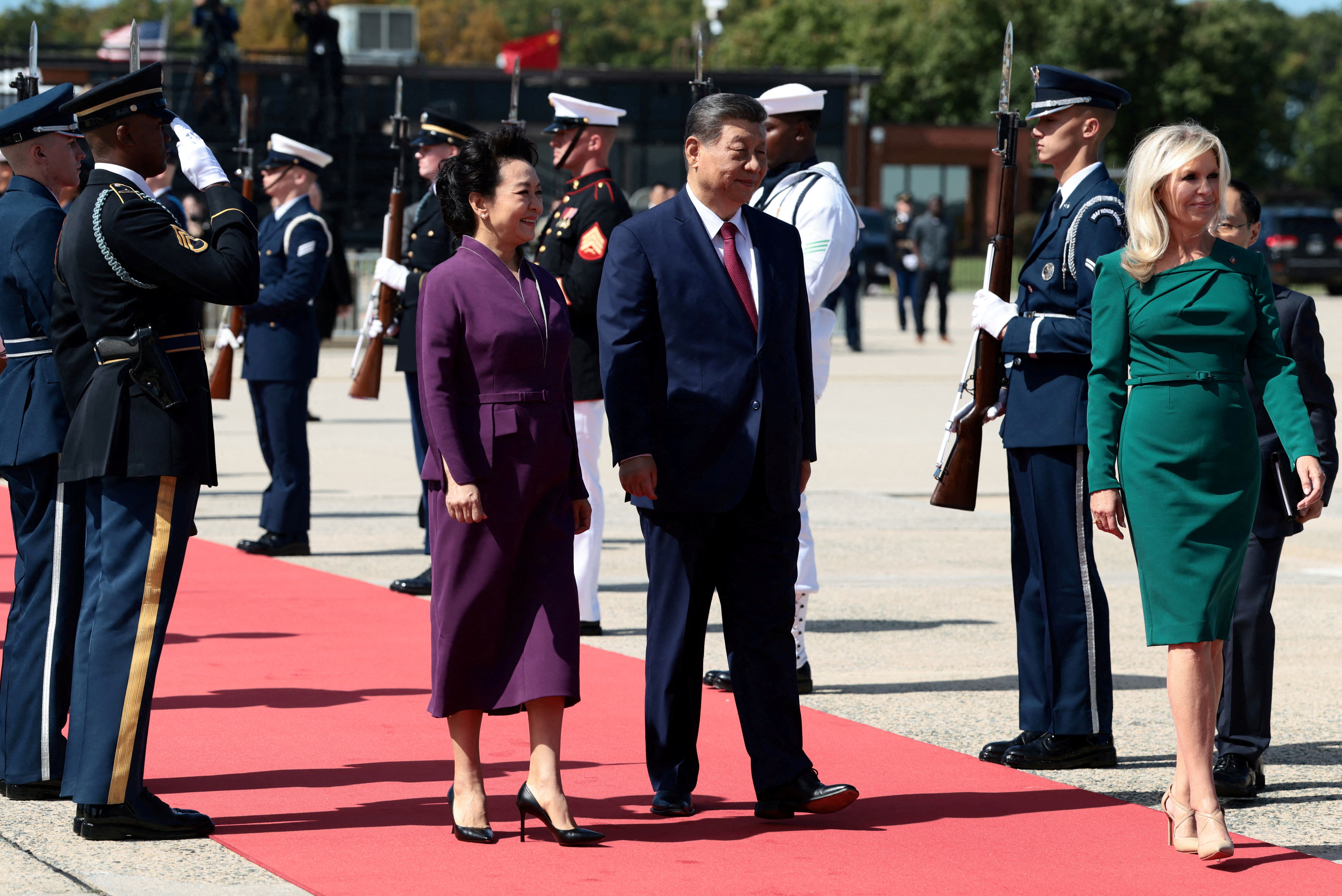 Chinese leader Xi Jinping and his wife Peng Liyua walk
