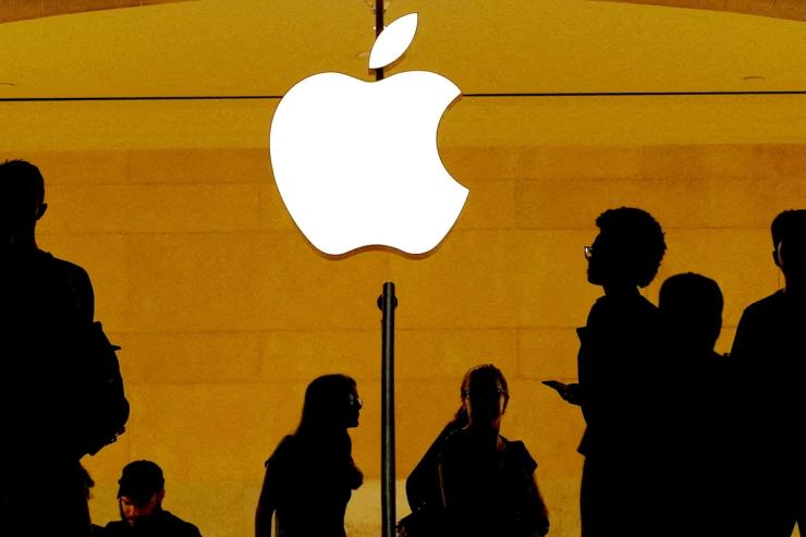 Customers walk past an Apple logo inside of an Apple store at Grand Central Station in New York, US.