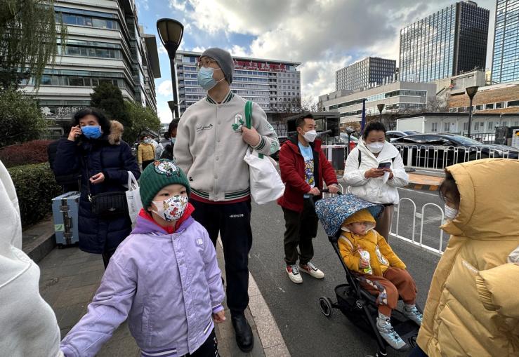 People leave a children’s hospital in Beijing, China in November 2023