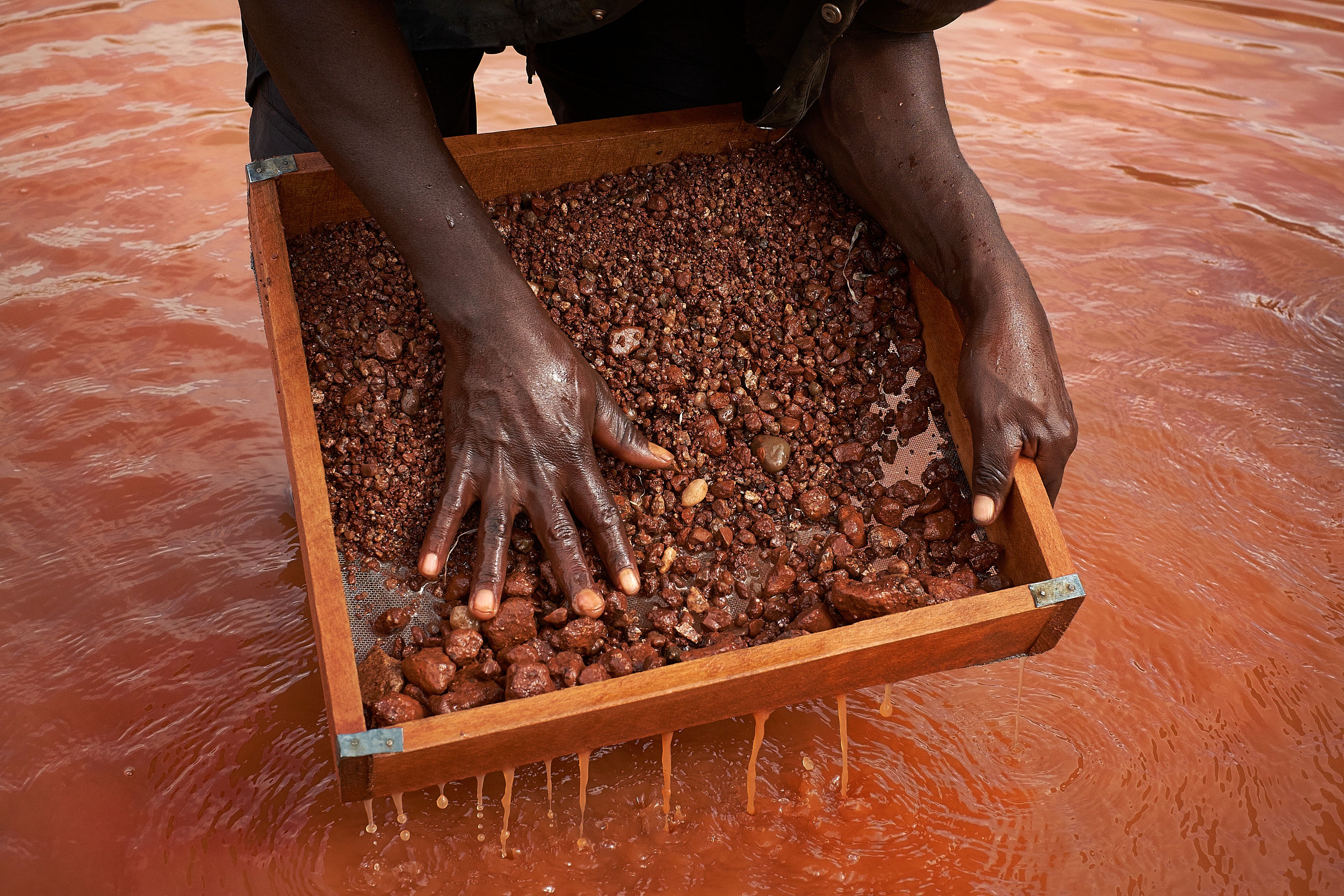 Closeup of miner sifting through the diamond-rich rock fragments.