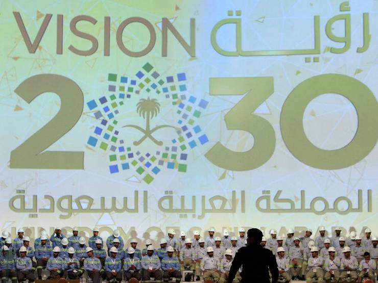 Banner shows Saudi Vision for 2030 as a soldier stands guard at the inauguration of several energy projects in Ras Al Khair, Saudi Arabia, November 29, 2016.