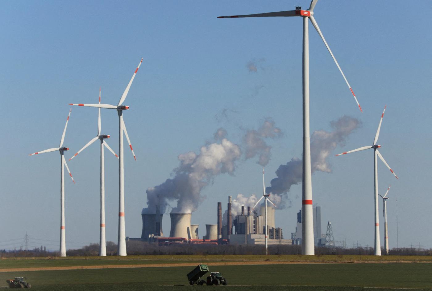  Wind power stations of German utility RWE, one of Europe's biggest electricity companies are pictured in front of RWE's brown coal fired power plants of Neurath, Germany, March 18, 2022. REUTERS/Wolfgang Rattay//File Photo