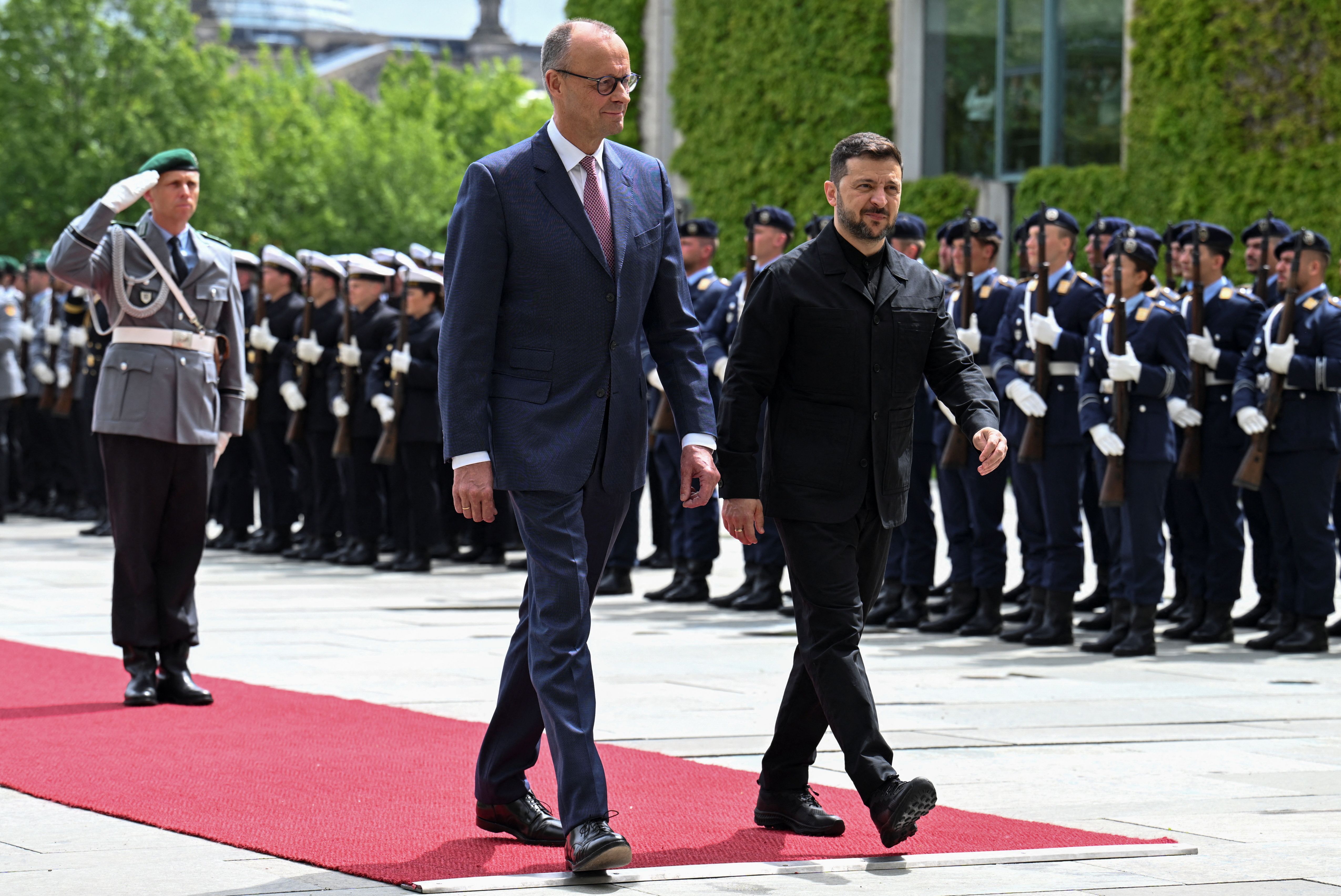 German Chancellor Friedrich Merz walks with Ukrainian President Volodymyr Zelenskyy.