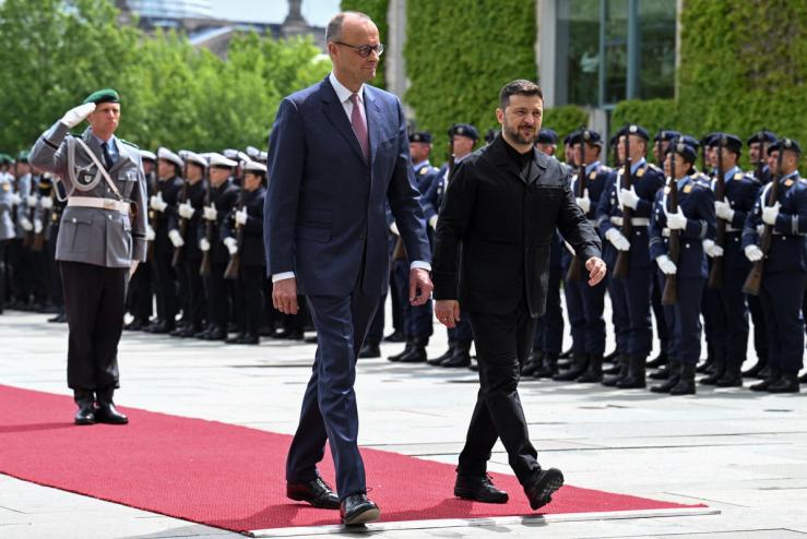 German Chancellor Friedrich Merz walks with Ukrainian President Volodymyr Zelenskyy.