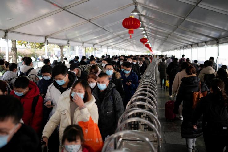 People walk with their luggage at a railway station during the annual Spring Festival travel rush ahead of the Lunar New Year in Shanghai on Jan. 16