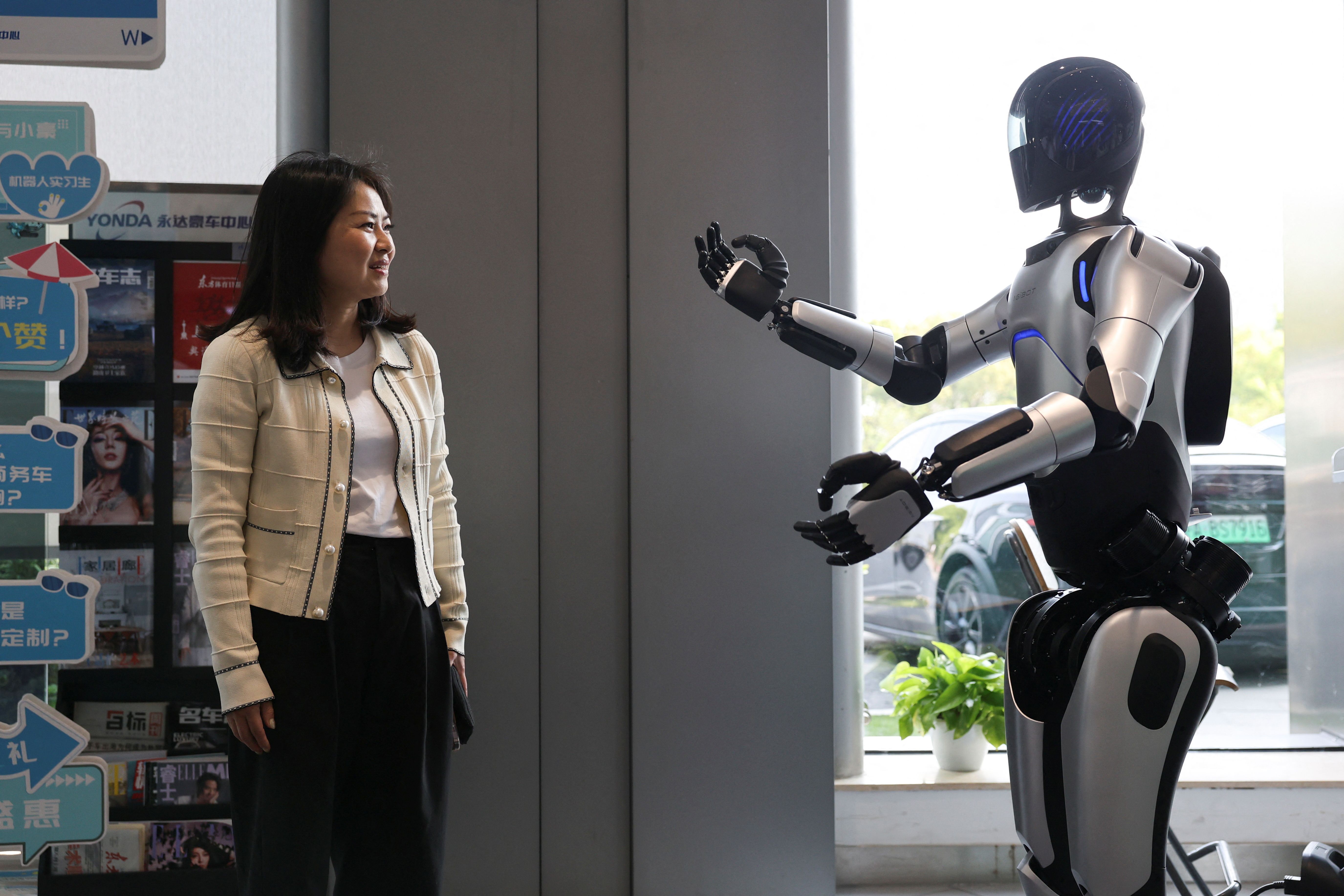 A customer communicates with an AgiBot humanoid robot.