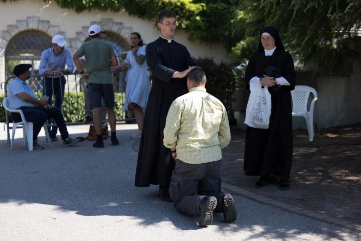 A faithful receives a blessing in front of the traditionalist Catholic Society of Saint Pius X (SSPX) in Econe, Switzerland