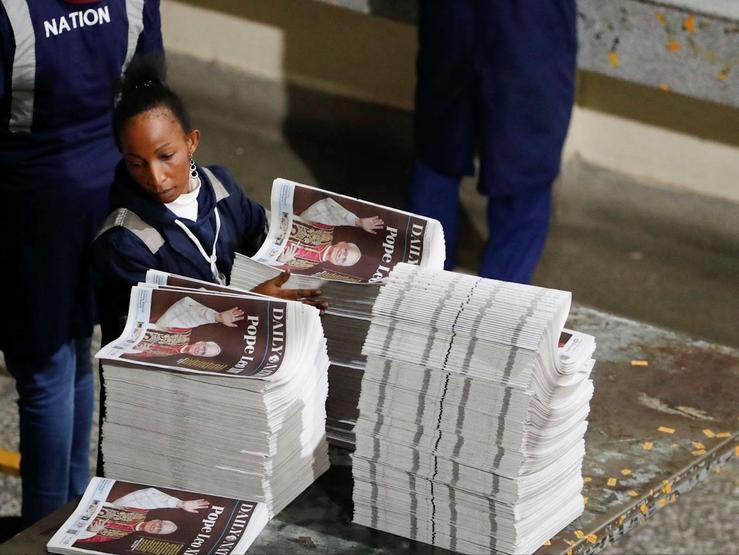 A worker arranges printed newspapers for circulation at the Nation Media Group printing press, Nairobi, Kenya, May 8, 2025.