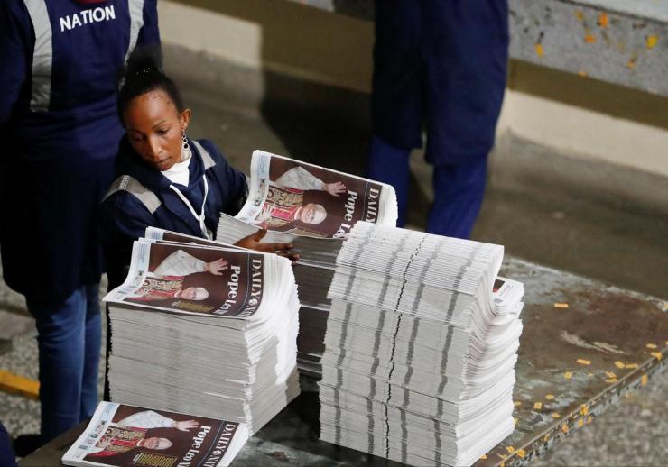 A worker arranges printed newspapers for circulation at the Nation Media Group printing press, Nairobi, Kenya, May 8, 2025.