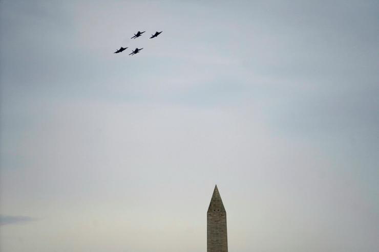 Fighter jets fly over the Washington Monument.