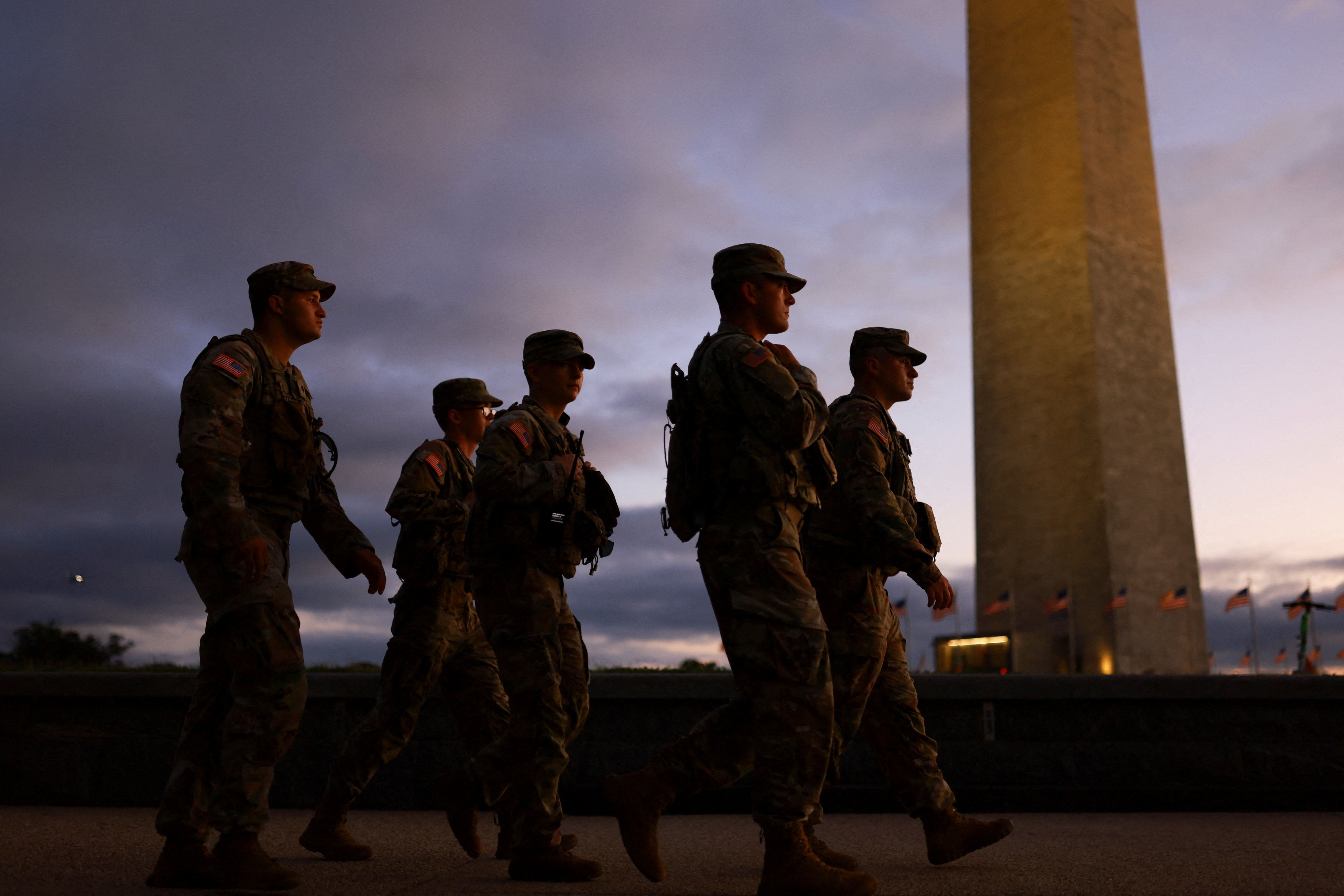 Members of the National Guard walk at the National Mall in Washington, DC.