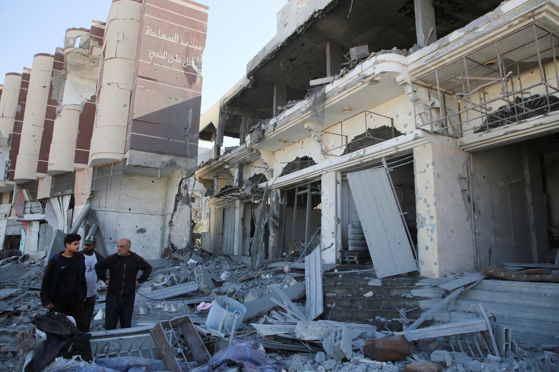 Palestinians inspect the site of an Israeli strike on a house, amid the Israel-Hamas conflict, in Khan Younis in the southern Gaza Strip